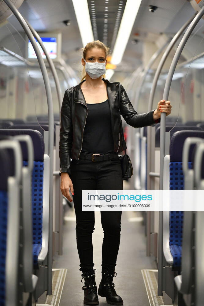 Woman with face mask, standing in S Bahn, Corona crisis, Stuttgart, Baden Württemberg, Germany Coronavirus