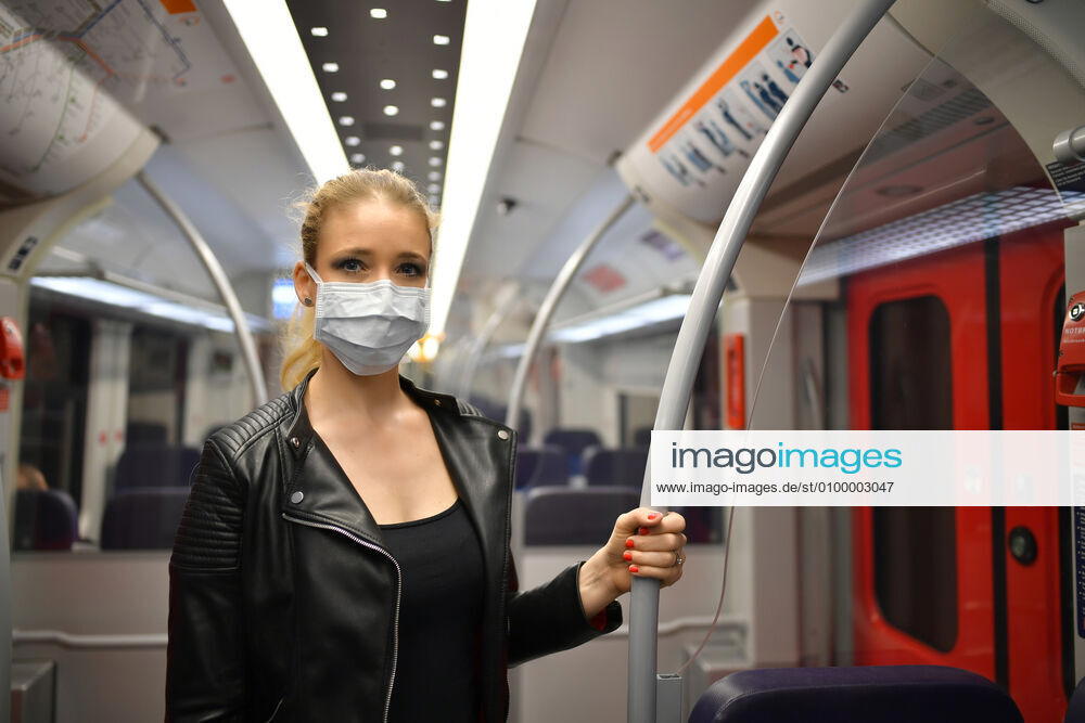 Woman with face mask, standing in S Bahn, Corona crisis, Stuttgart, Baden Württemberg, Germany Coronavirus
