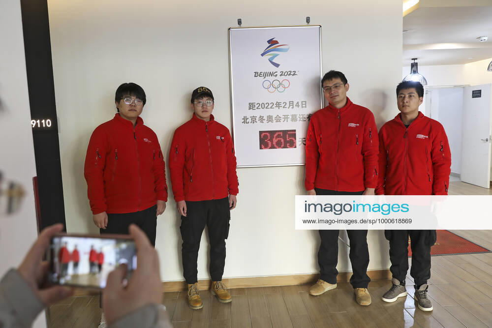 Workers pose for photos next to a countdown clock for the Beijing 2022 Olympic Winter games, Winterspiele,Spiele, Summer games at Chongli Yunding ski resort, a 2022 Winter Olympics venue, on February 4, 2021 in Zhangjiakou, Hebei Province of China. China on Thursday marks the one-year countdown to the 2022 Winter Olympics, which will open on February 4 next year.