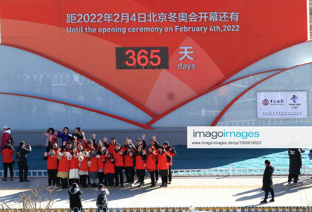 People pose for photos in front of a countdown clock for the Beijing 2022 Olympic Winter games, Winterspiele,Spiele, Summer games at a square on February 4, 2021 in Zhangjiakou, Hebei Province of China. China on Thursday marks the one-year countdown to the 2022 Winter Olympics, which will open on February 4 next year.