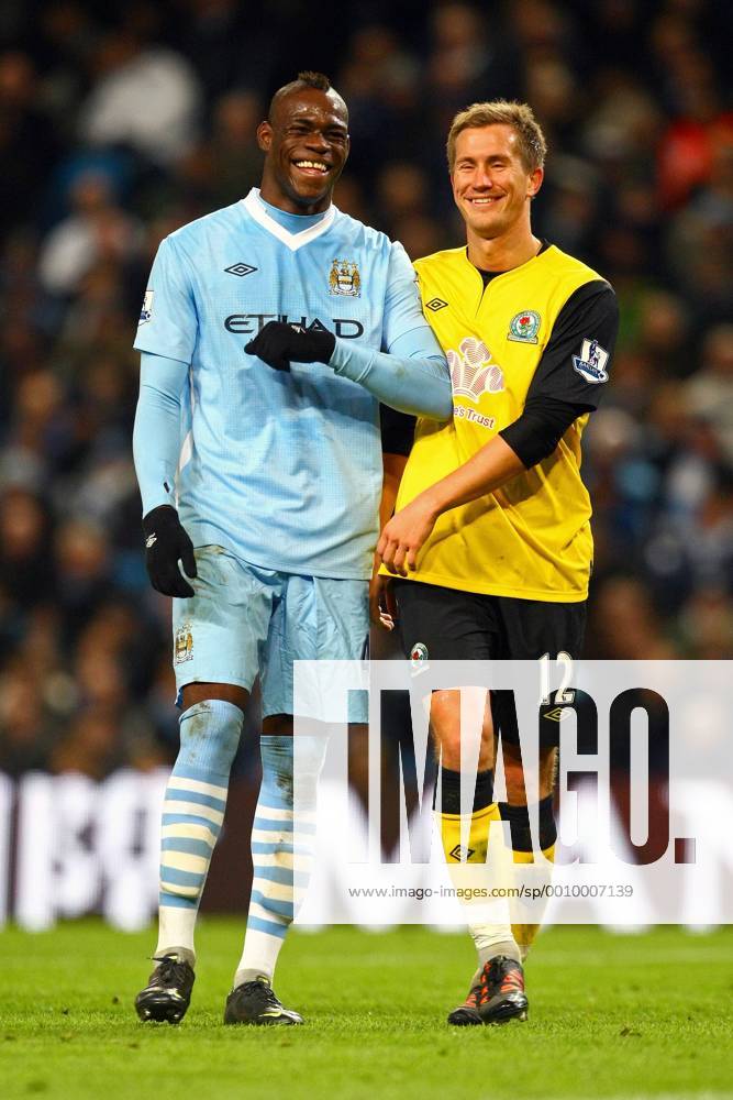 Football - Premier League - Manchester City vs. Blackburn Rovers Mario Balotelli of Manchester City shares a joke with Morten Gamst Pedersen of Blackburn Rovers at the Etihad Stadium