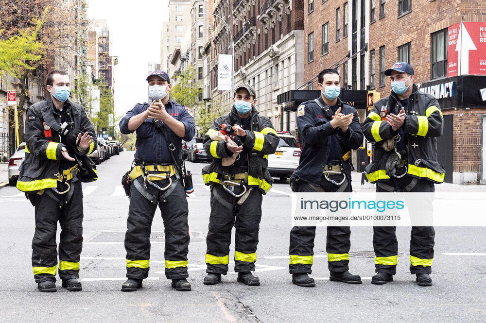 New York, NY, U.S: April 27, 2020 - New York, NY, United States: New York City Firemen at the corner of West 113th Street and Amsterdam Avenue clapping and cheering at 7:00pm for frontline and essential workers facing the Coronavirus. New York U.S. - ZUMAb161 20200427_zap_b161_005
