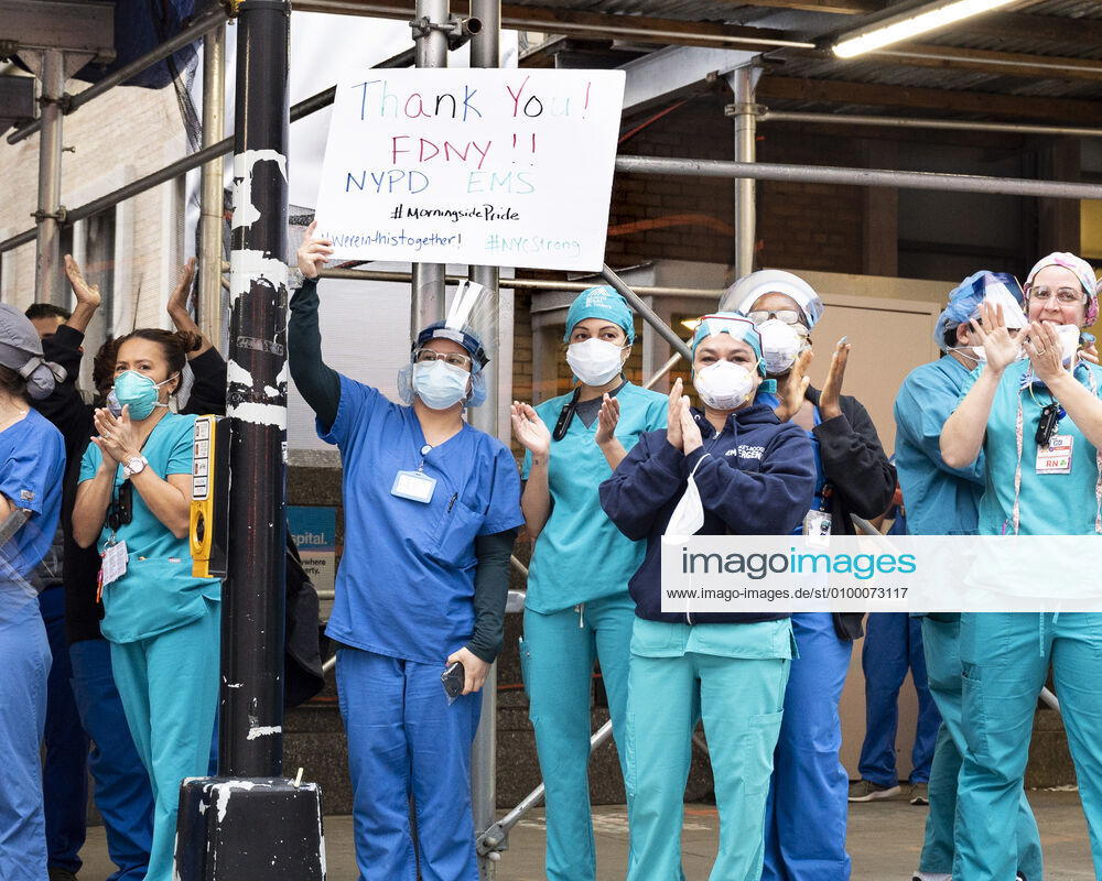 New York, NY, U.S: April 27, 2020 - New York, NY, United States: People from Mount Sinai Morningside hospital at the corner of West 113th Street and Amsterdam Avenue clapping and cheering at 7:00pm for frontline and essential workers facing the Coronavirus. New York U.S. - ZUMAb161 20200427_zap_b161_006