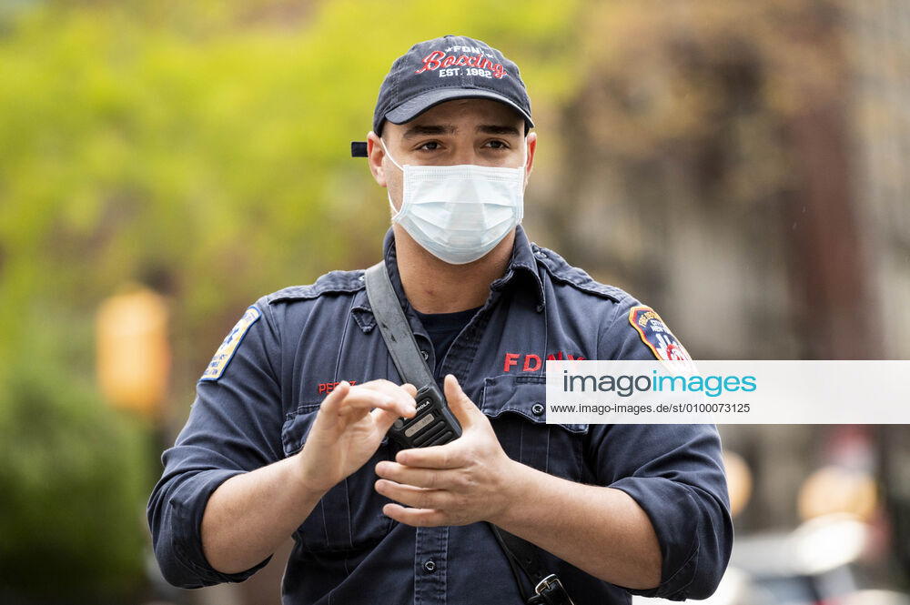 New York, NY, U.S: April 27, 2020 - New York, NY, United States: New York City Firemen at the corner of West 113th Street and Amsterdam Avenue clapping and cheering at 7:00pm for frontline and essential workers facing the Coronavirus. New York U.S. - ZUMAb161 20200427_zap_b161_010