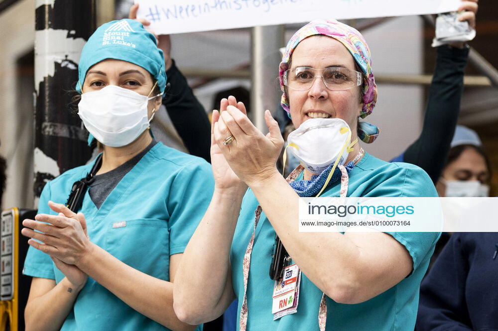 New York, NY, U.S: April 27, 2020 - New York, NY, United States: People from Mount Sinai Morningside hospital at the corner of West 113th Street and Amsterdam Avenue clapping and cheering at 7:00pm for frontline and essential workers facing the Coronavirus. New York U.S. - ZUMAb161 20200427_zap_b161_013