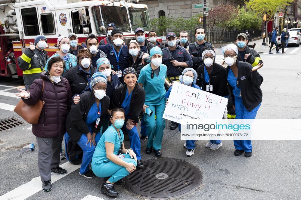 New York, NY, U.S: April 27, 2020 - New York, NY, United States: New York City Firemen and people working at Mount Sinai Morningside hospital standing at the corner of West 113th Street and Amsterdam Avenue clapping and cheering at 7:00pm for frontline and essential workers facing the Coronavirus. New York U.S. - ZUMAb161 20200427_zap_b161_017