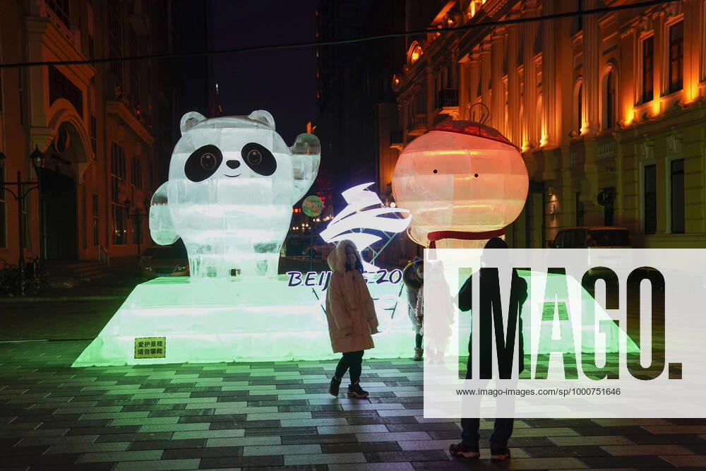 People look at an ice sculpture depicting the mascot of Beijing 2022 Olympic Winter games, Winterspiele,Spiele, Summer games Bing Dwen Dwen and the mascot of Beijing 2022 Paralympic Winter Games Shuey Rhon Rhon at Central Street on the eve of Chinese New Year, the Year of the Ox, on February 11, 2021 in Harbin, Heilongjiang Province of China.