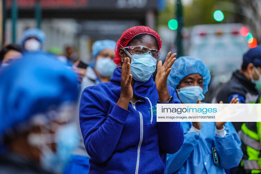 Health professionals are honored by residents and firefighters outside a Manhattan hospital in New York City on Monday during the Coronavirus COVID-19 pandemic in the United States. New York USA - ZUMAc233 20200427_zsp_c233_037