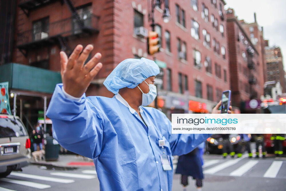 Health professionals are honored by residents and firefighters outside a Manhattan hospital in New York City on Monday during the Coronavirus COVID-19 pandemic in the United States. New York USA - ZUMAc233 20200427_zsp_c233_059