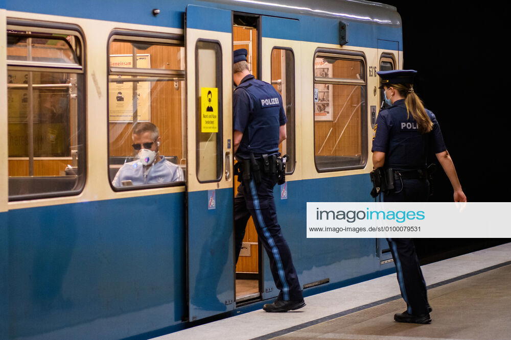 (200428) -- MUNICH, April 28, 2020 (Xinhua) -- Two policemen wearing face masks walk into a subway cabin in Munich, Germany, April 27, 2020. In most German states, face masks or an equivalent mouth-and-nose cover have become mandatory on Monday when people travel by bus or train or go shopping. (Photo by Kevin Voigt Xinhua) GERMANY-MUNICH-COVID-19-FACE MASK