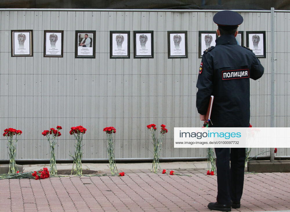 A police officer by portraits of medical workers who died after contracting the novel coronavirus by the offices of St Petersburg s Healthcare Committee in Malaya Sadovaya Street. The wall of memory was created by St Petersburg resident Irina Maslova. Peter Kovalev TASS TS0D752B