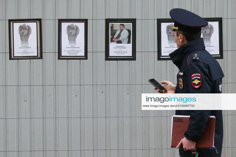 A police officer by portraits of medical workers who died after contracting the novel coronavirus by the offices of St Petersburg s Healthcare Committee in Malaya Sadovaya Street. The wall of memory was created by St Petersburg resident Irina Maslova. Peter Kovalev TASS TS0D752C