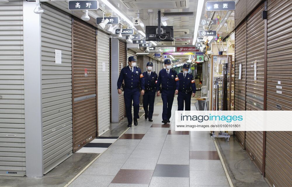 New coronavirus Police officers patrol Tokyo s Ameyoko shopping area on April 28, 2020, amid the coronavirus pandemic.