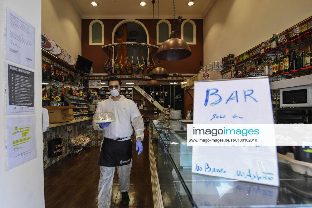 Bartender is on his way to deliver coffee in Naples, after the lockdown due to Government Decree declaring all of Italy a protected area to combat Covid-19 - Coronavirus infection. A new Government Decree has established rules for gradually reopening economic and social activities from today.