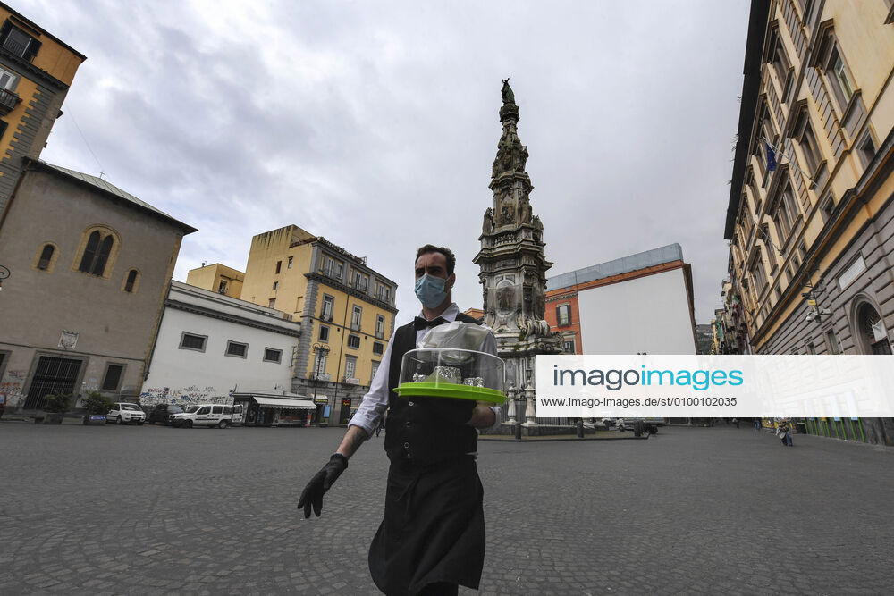 Bartender is on his way to deliver coffee in Naples, after the lockdown due to Government Decree declaring all of Italy a protected area to combat Covid-19 - Coronavirus infection. A new Government Decree has established rules for gradually reopening economic and social activities from today.