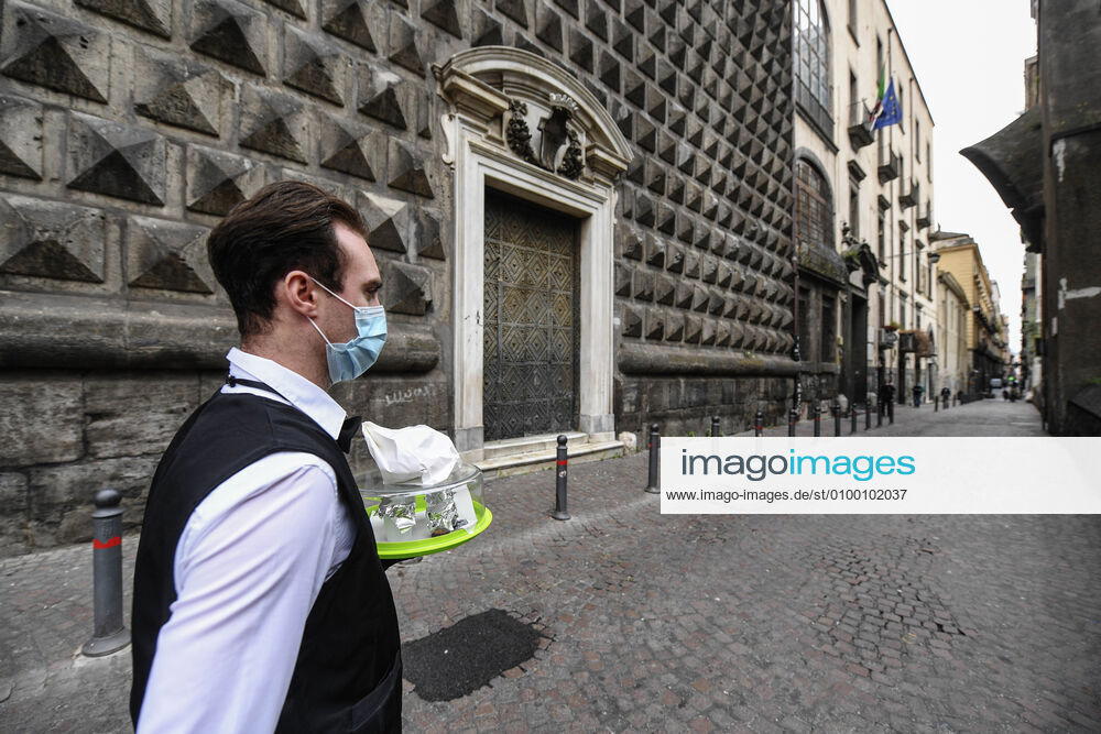Bartender is on his way to deliver coffee in Naples, after the lockdown due to Government Decree declaring all of Italy a protected area to combat Covid-19 - Coronavirus infection. A new Government Decree has established rules for gradually reopening economic and social activities from today.