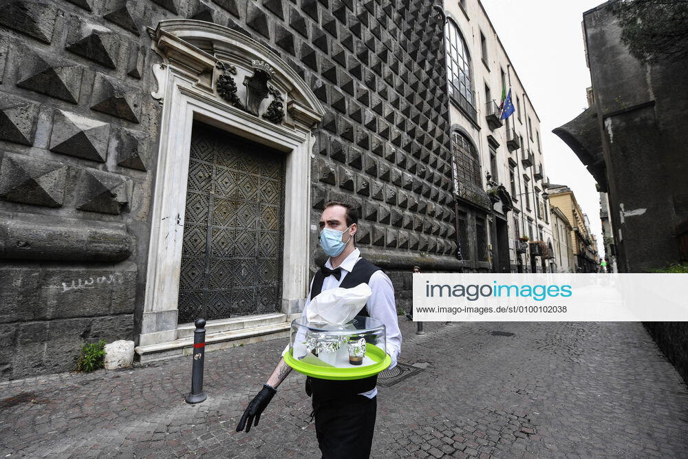 Bartender is on his way to deliver coffee in Naples, after the lockdown due to Government Decree declaring all of Italy a protected area to combat Covid-19 - Coronavirus infection. A new Government Decree has established rules for gradually reopening economic and social activities from today.