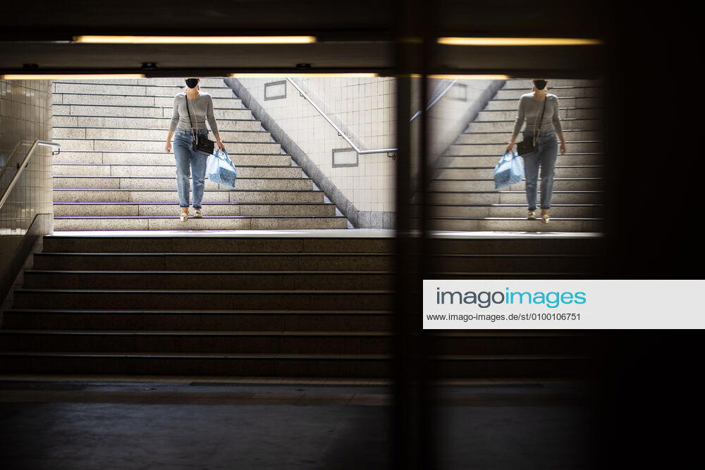 A woman with a face mask enters the underground station in Berlin, 28 04 2020 Germany-wide there is a mask obligation in public transport Berlin Germany