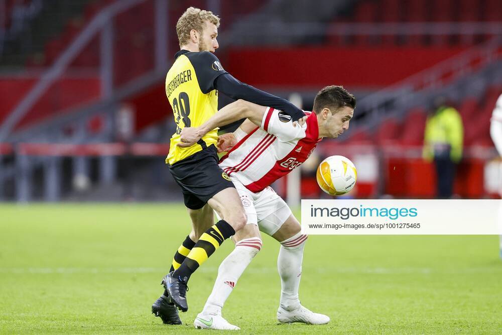 , Johan Cruijff Arena , Dutch football , Europa League , round of sixteen first leg , season 2020 2021. (R-L)Ajax player Dusan Tadic and Young Boys player Fabian Lustenberger during the match Ajax vs Young Boys Ajax - Young Boys x11072506x