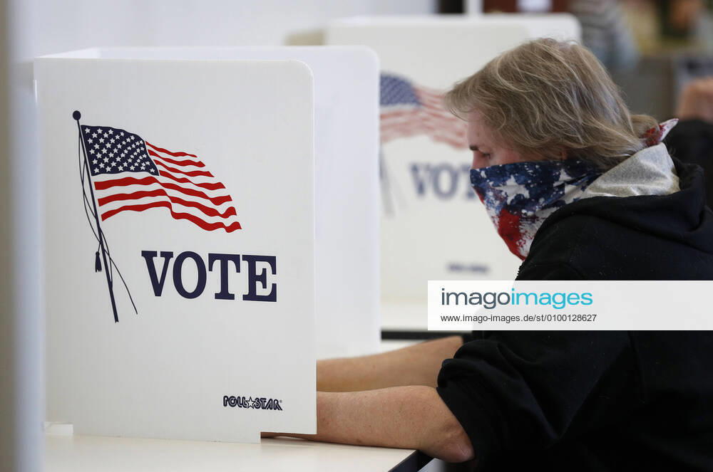 A voter places his ballot in the Ohio primary election while observing social-distancing during to the Coronavirus pandemic in Medina Ohio on Tuesday, April 28, 2020. Ohio canceled its March 17 Democratic presidential primary, with today being the last day to vote-by-mail or in person. CLE20200428113 AARONxJOSEFCZYK