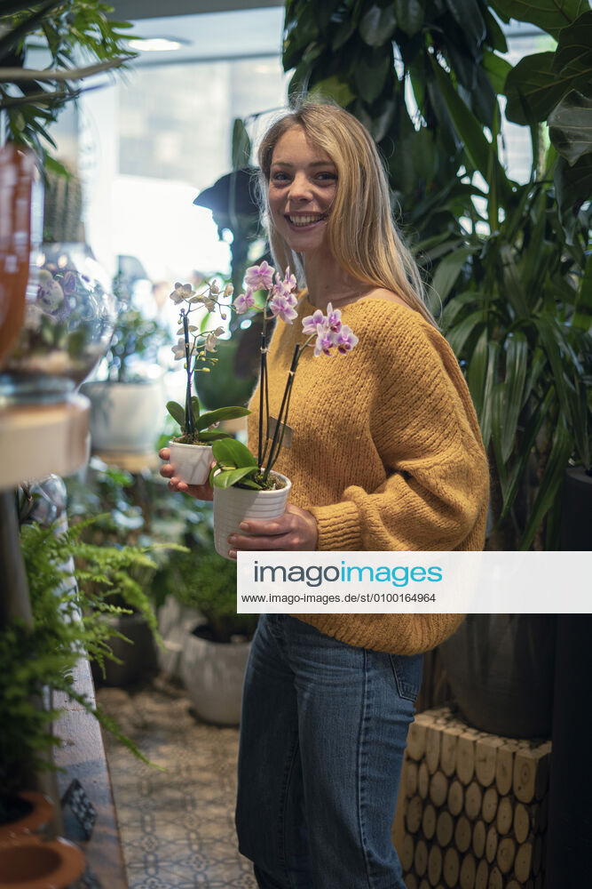 Young woman standing in flower shop