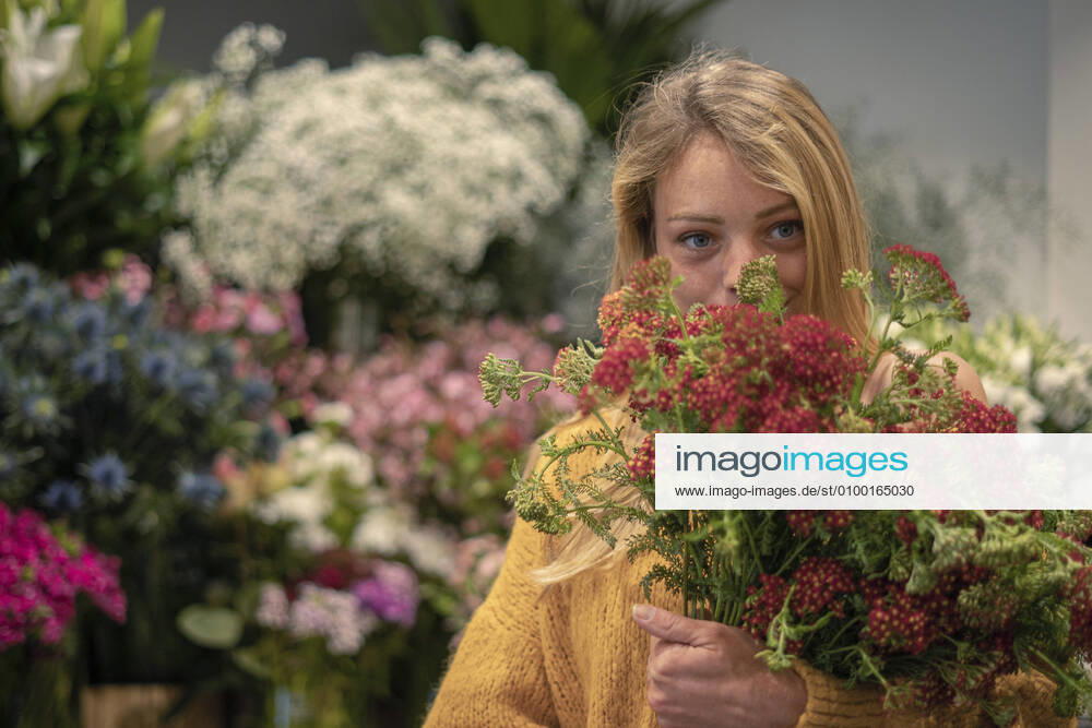 Young woman standing in flower shop