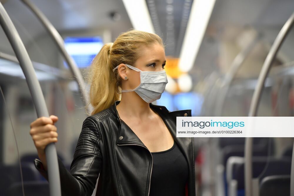 Woman with face mask, standing in S Bahn, Corona crisis, Stuttgart, Baden Württemberg, Germany, Europe