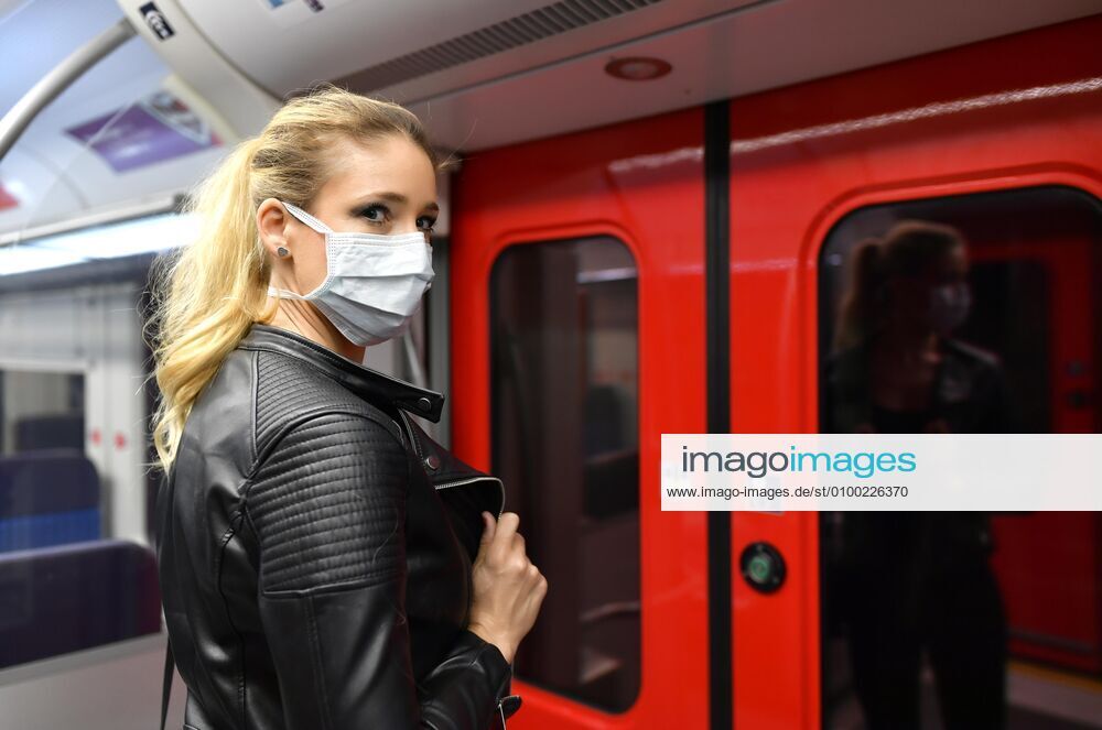 Woman with face mask, standing in S Bahn, Corona crisis, Stuttgart, Baden Württemberg, Germany, Europe
