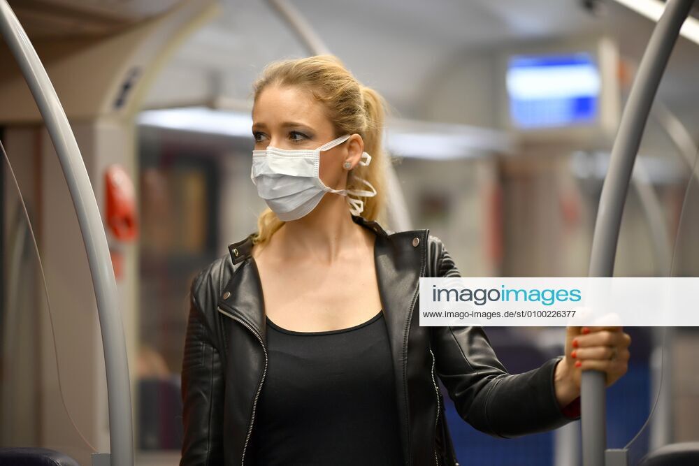 Woman with face mask, standing in S Bahn, Corona crisis, Stuttgart, Baden Württemberg, Germany, Europe