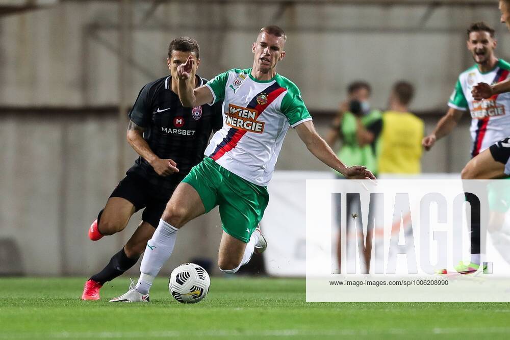 SOCCER - UEFA EL, Luhansk vs Rapid ZAPORIZHIA,UKRAINE,26.AUG.21 - SOCCER - UEFA Europa League play off, Zorya Luhansk vs SK Rapid Wien. Image shows Artem Gromov (Luhansk) and Srdjan Grahovac (Rapid). GEPAxpictures xPhilippxBrem