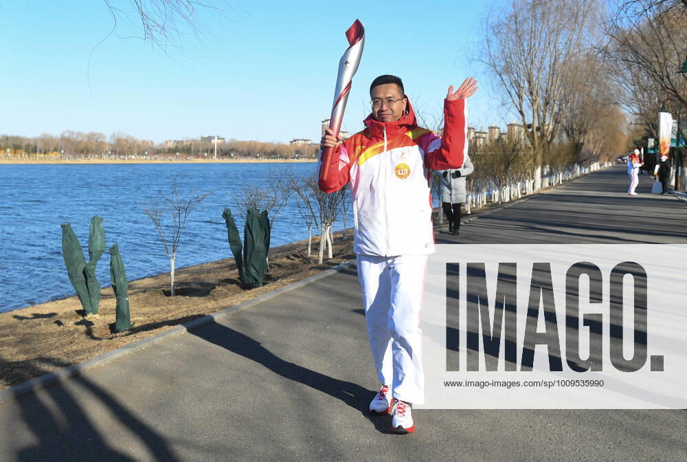 (220204) -- BEIJING, Feb. 4, 2022 -- Torch bearer Wang Tuo runs with the torch during the Beijing 2022 Olympic Torch Relay at the Grand Canal Forest Park in Tongzhou District of Beijing, capital of China, Feb. 4, 2022. ) (BEIJING2022)CHINA-BEIJING-OLYMPIC TORCH RELAY (CN) RenxChao