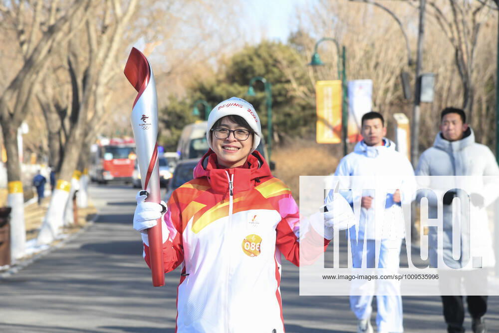 (220204) -- BEIJING, Feb. 4, 2022 -- Torch bearer Jia Xiaohong runs with the torch during the Beijing 2022 Olympic Torch Relay at the Grand Canal Forest Park in Tongzhou District of Beijing, capital of China, Feb. 4, 2022. ) (BEIJING2022)CHINA-BEIJING-OLYMPIC TORCH RELAY (CN) RenxChao