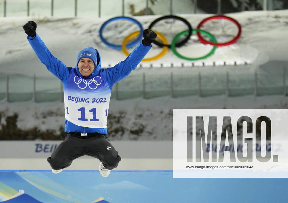 KW06 Quentin Fillon Maillet of France jumps on the podium after winning the gold medal in the Men s 20km Individual Biathlon event at the 2022 Winter Olympics in Zhangjiakou, China on Tuesday, February 8, 2022. Anton Smolski of Belarus won the silver and Norway s Johannes Thingnes Boe won the bronze . OLY20220208604 BOBxSTRONG