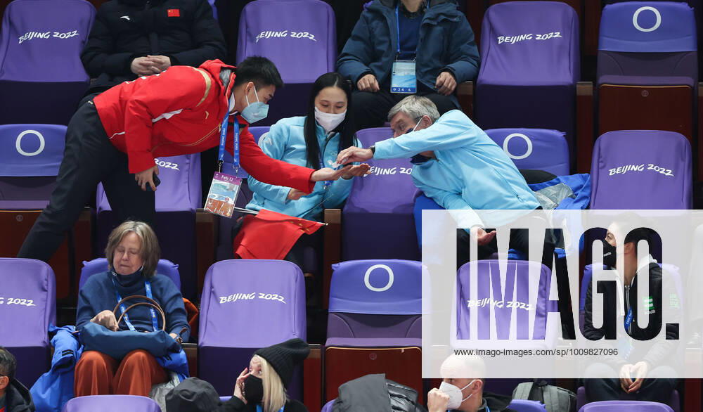 (220213) -- BEIJING, Feb. 13, 2022 -- International Olympic Committee (IOC) president Thomas Bach (R) shares hand sanitizer with China s gold medalist Gao Tingyu (L) and IOC member Zhang Hong during short track Speed skating, Eisschnelllauf events at Capital Indoor Stadium in Beijing, capital of China, Feb. 13, 2022. ) (BEIJING2022)CHINA-BEIJING-OLYMPIC Winter games, Winterspiele,Spiele, Summer games SHORT TRACK SPEED SKATING-IOC-BACH (CN) CaoxCan