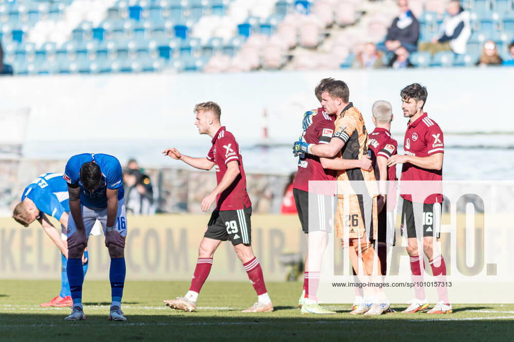 Rostock, Germany 26 February 2022 2 BL 2021 2022 FC Hansa Rostock vs 1 FC Nuernberg v li Hanno Behrens Hansa Rostock and Ryan Malone Hansa Rostock unhappy right the team of Nuernberg celebrates the victory DFB regulations prohibit any use of photographs as image sequences and or quasi video Ostseestadion Mecklenburg Vorpommern