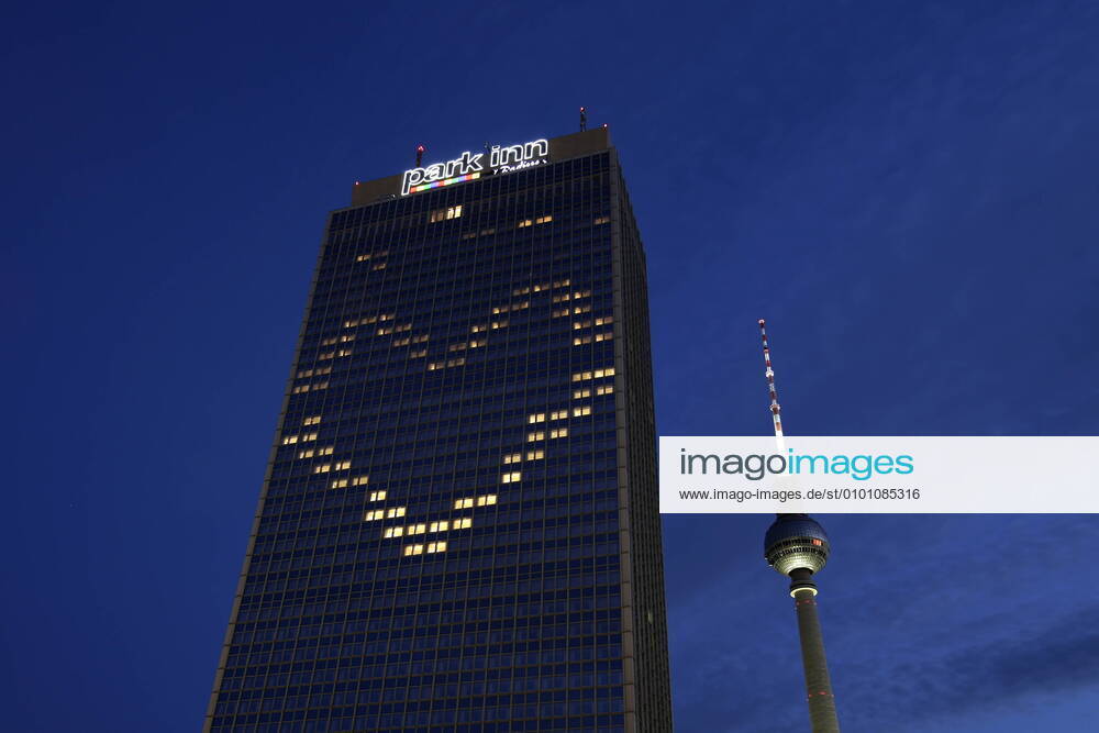 Berlin, Germany Photo Hotel Park Inn and the television tower at Alexanderplatz During the corona crisis the Hotel Park Inn at Alexanderplatz illuminated some windows in such a way that they form a heart together