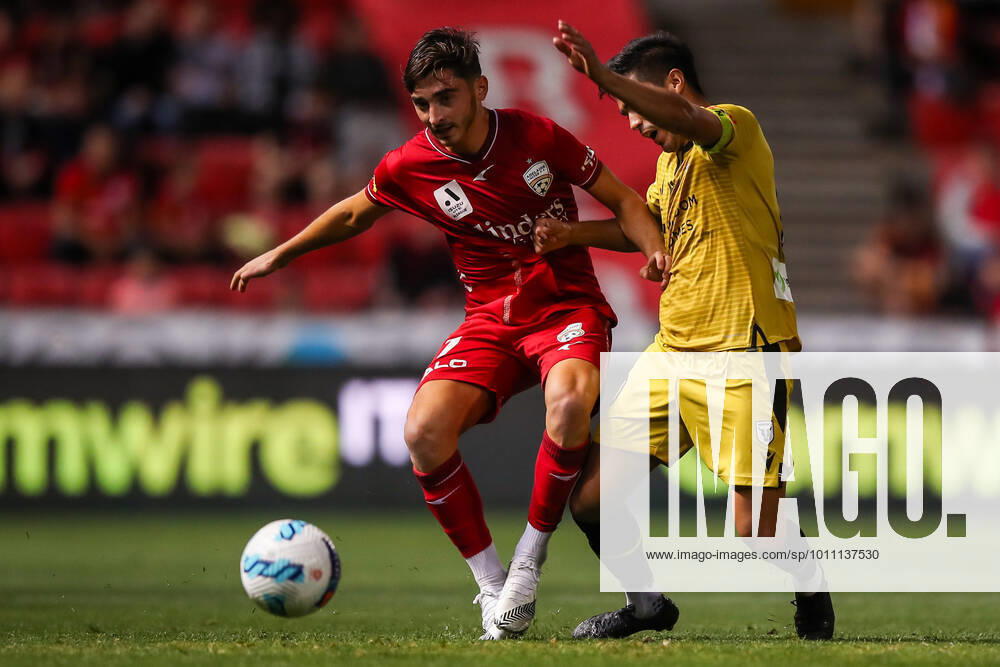 ALEAGUE ADELAIDE MACARTHUR, Joshua Cavallo of Adelaide United is tackled by Ulises Davila of the Bulls during the A-League match between Adelaide United and Macarthur FC at Coopers Stadium in Adelaide, Friday, April 8, 2022. ( NO ARCHIVING, , NO USE IN BOOKS WITHOUT CONSENT ADELAIDE SA AUSTRALIA