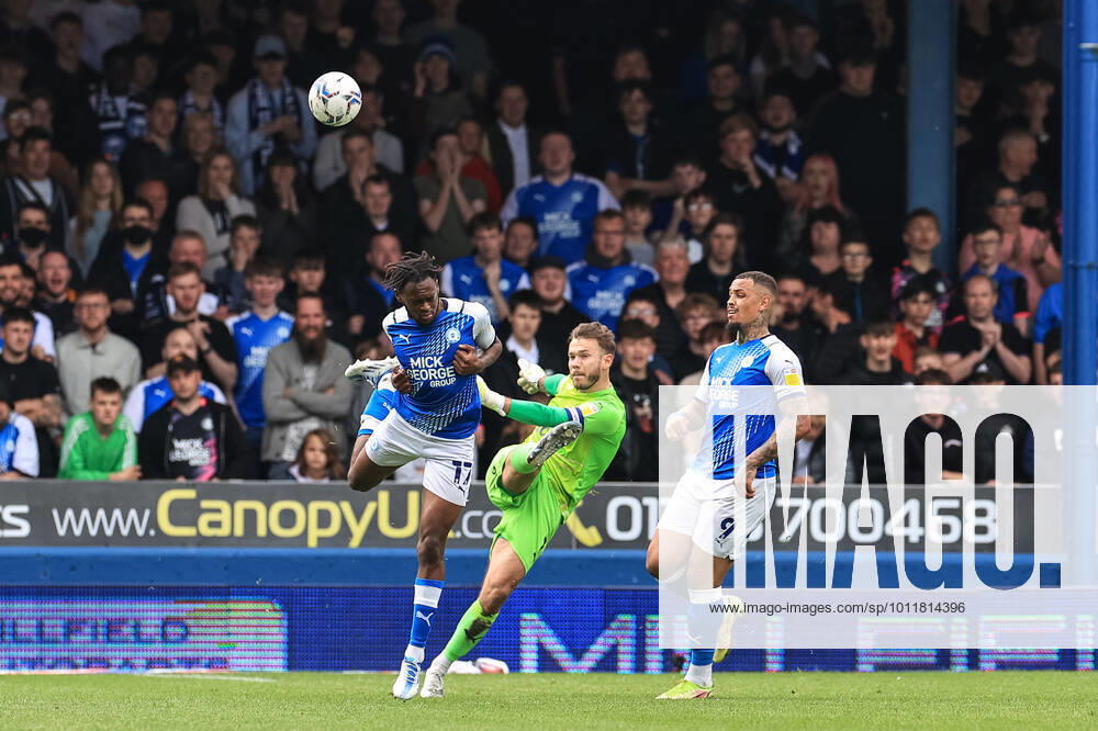 Sky Bet Championship Peterborough v Blackpool Chris Maxwell 1 of Blackpool clears the ball under pressure from Ricky Jade-Jones 17 of Peterborough United Peterborough Weston Homes Stadium Cambridgeshire United Kingdom