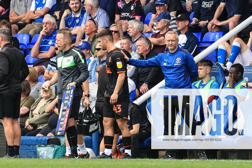 Sky Bet Championship Peterborough v Blackpool Neil Critchley head coach of Blackpool pats Jake Daniels 43 of Blackpool on the back as he prepares to make his club debut Peterborough Weston Homes Stadium Cambridgeshire United Kingdom