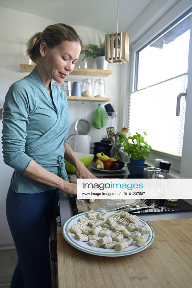 Woman preparing gnocchi in kitchen model released Symbolfoto property released ECPF00900