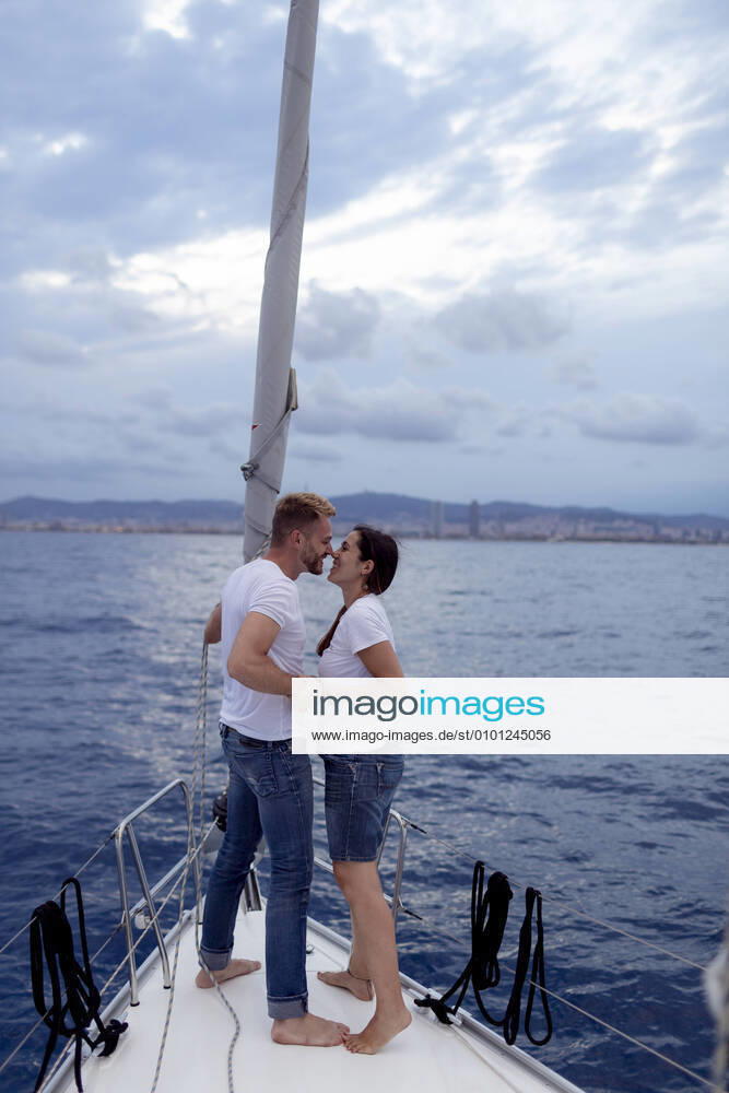 Couple kissing during sailing trip model released Symbolfoto GMLF00095