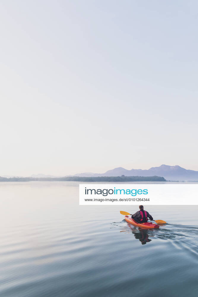 Woman standing on sup board in the morning on a lake, Germany model released Symbolfoto MMAF01313