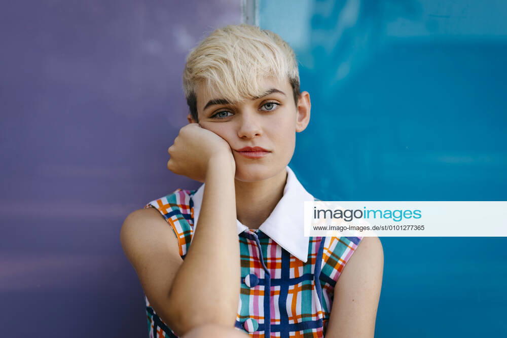 Portrait of female teenager wearing colorful dress leaning on multicolored glass pane model released Symbolfoto TCEF00549