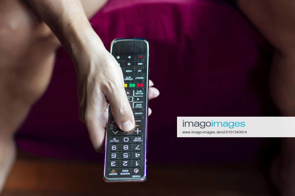 Close-up of a person changing the television with the remote control in quarantine period Madrid, Community of Madrid, Spain CR_IGMA200420-348348-01,model released, Symbolfoto