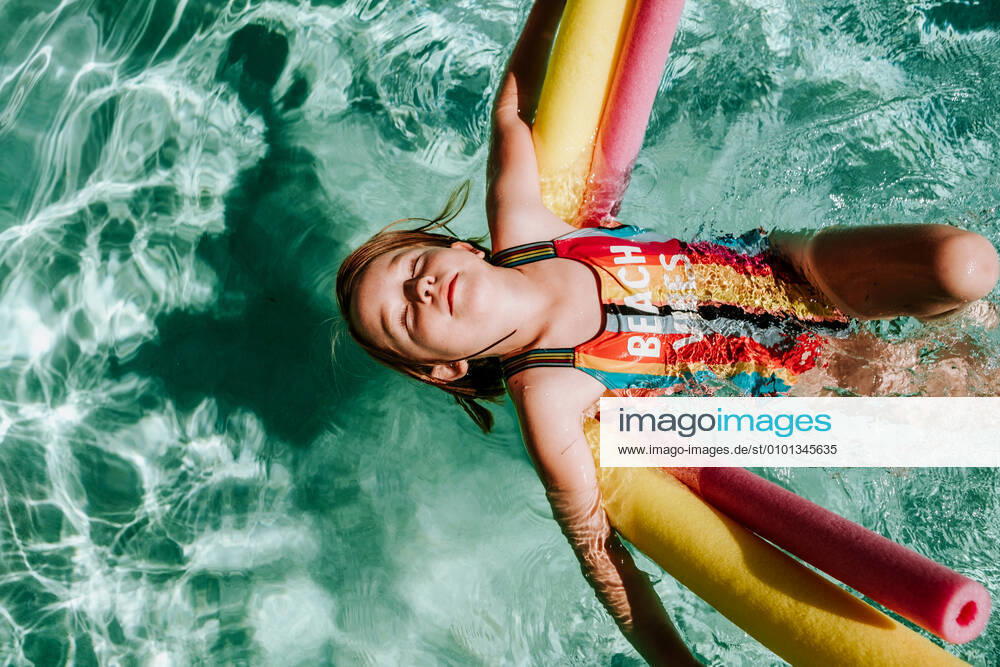 Young girl floating on her back in pool with eyes closed Tucson, AZ, United States CR_JEMI200430A-277481-01,model released, Symbolfoto