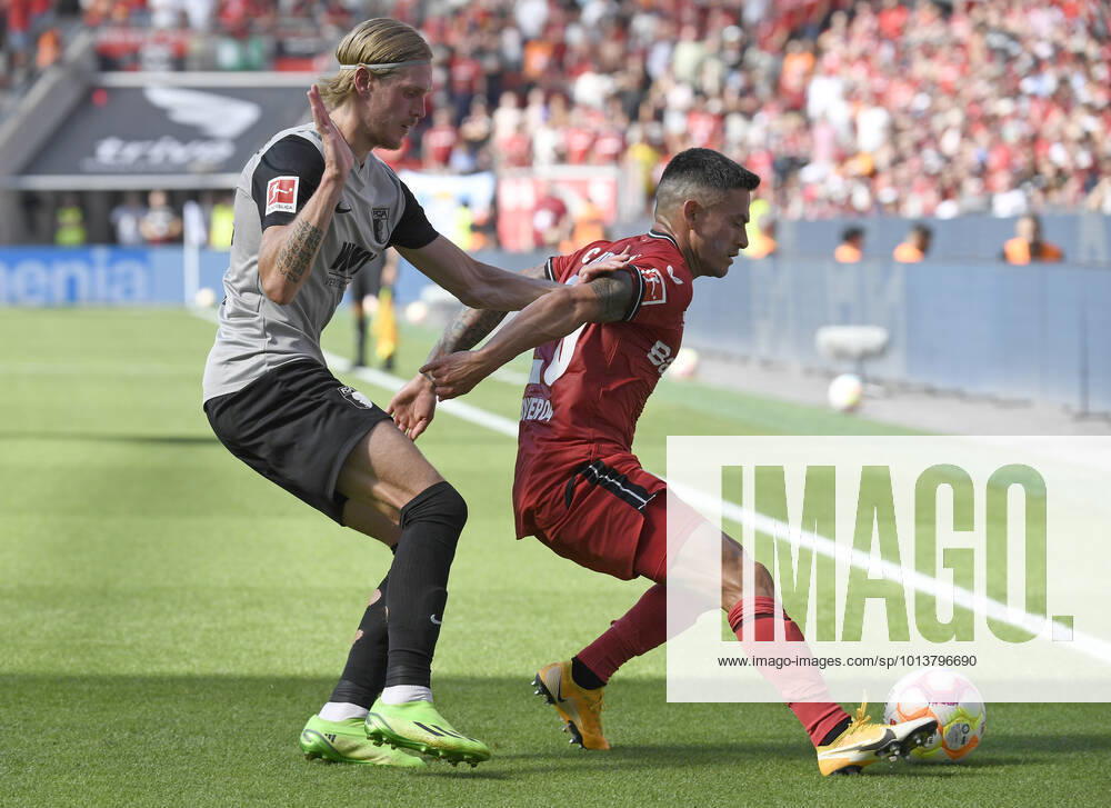 Leverkusen, Germany, BayArena, Bayer 04 Leverkusen vs FC Augsburg 1 Bundesliga, Fredrik Jensen FC Augsburg and Charles Aranguiz Bayer 04 Leverkusen in duel Photo Ralf Treese DFB DFL REGULATIONS PROHIBIT ANY USE OF PHOTOGRAPHS AS IMAGE SEQUENCES AND OR QUASI VIDEO Leverkusen BayArena North Rhine Westphalia Germany 521_LEVAUG20220813_024 Treese-521