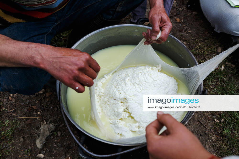 ZAKARPATIA REGION, UKRAINE - Wringing of the cottage cheese over a bowl of whey, Khust district, Zakarpattia Region, western Ukraine. Cheese making by shepherds of Zakarpattia Region