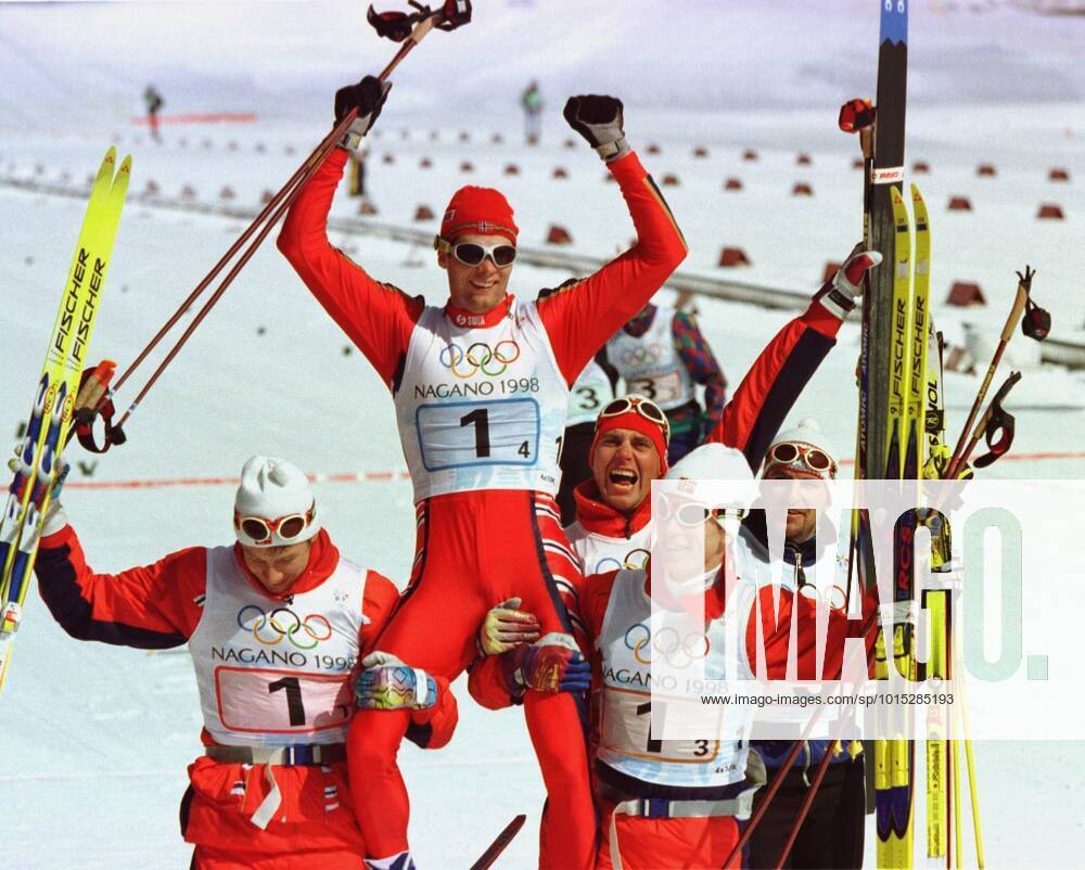 Nagano 980218 4 x 10 km The Norwegian gold team, Sture Sivertsen, Erling Jevne and Björn Dählie carry the last man Thomas Alsgaard in gold chair NAGANO JAPAN Skis
