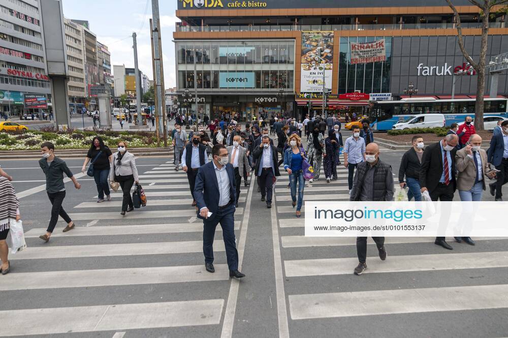People wearing face masks, walk on a street in Ankara, Turkey, June 01, 2020. Many businesses across Turkey reopen for the first time after over two months of closure amid a slowdown in the spread of COVID-19. Restaurants, cafes, show centers, concert halls, cafes, hookah halls, parks, daycare centers, kindergartens, libraries, sports facilities, swimming pools, and museums operational from June 1 as part of the new normalization process. The Ministry announced on 1 June that normalization steps would be taken in Turkey. As businesses opened as part of the steps taken, Life began to return to normal, the country s capital city, Ankara. TunahanxTurhanx PhotoxAgency 1048_02_IMG_7433