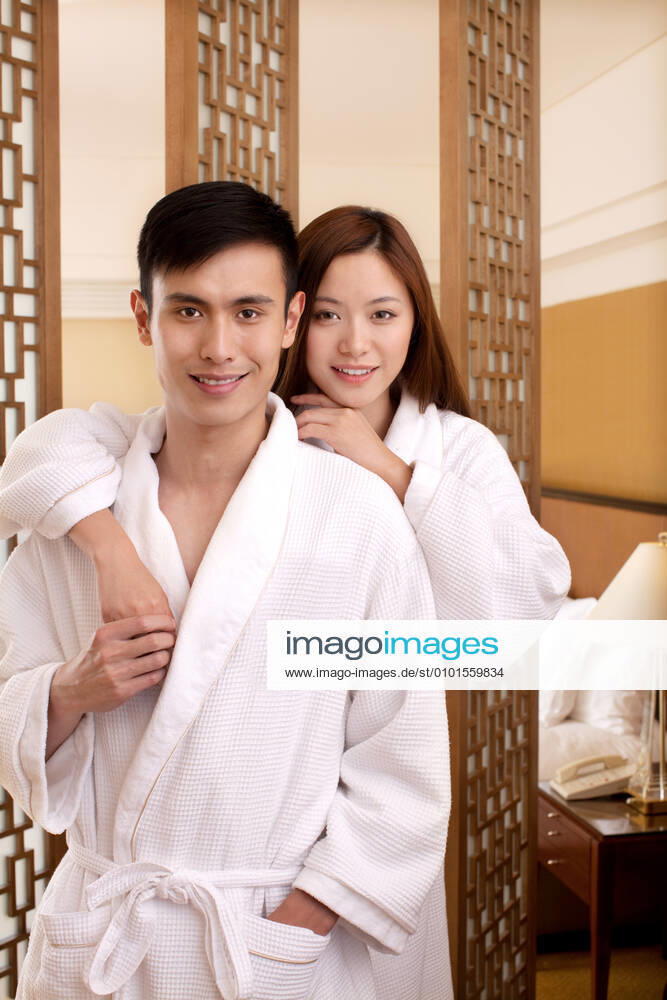 A couple enjoying life in a hotel room 55295075424535837